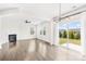 Bright living room with hardwood floors, fireplace, modern light fixture and sliding glass door to outside at 3022 Oakmere Rd, Waxhaw, NC 28173