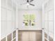 Sun-filled room featuring a ceiling fan, hardwood floors, and French doors leading to another living space at 3022 Oakmere Rd, Waxhaw, NC 28173