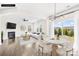 Open-concept living and dining area with hardwood floors, modern decor, and a fireplace at 3022 Oakmere Rd, Waxhaw, NC 28173