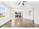 Open-concept living space with hardwood floors, leading to a kitchen and outdoor patio at 3022 Oakmere Rd, Waxhaw, NC 28173