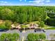Aerial view of community playground area, parking and walking trail surrounded by trees at 3022 Oakmere Rd, Waxhaw, NC 28173