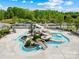 Aerial view of community pool area with slides, swimming pool, and beautiful landscaping at 3022 Oakmere Rd, Waxhaw, NC 28173