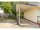 Exterior shot showcases covered parking space with brick and vinyl siding, offering ample space at 304 W Fourth St, Cherryville, NC 28021