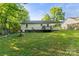 Expansive backyard featuring a deck, fire pit and lush green grass, perfect for outdoor gatherings at 304 W Fourth St, Cherryville, NC 28021
