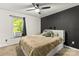 Bright bedroom with dark accent wall, a window, and a ceiling fan at 304 W Fourth St, Cherryville, NC 28021