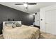 Inviting bedroom boasts a ceiling fan and dark accent wall at 304 W Fourth St, Cherryville, NC 28021