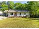Charming single-story home with covered porch, front yard, and carport, offering a cozy curb appeal at 304 W Fourth St, Cherryville, NC 28021