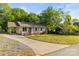 Inviting single-story home with a long driveway, carport, and a well-maintained front lawn at 304 W Fourth St, Cherryville, NC 28021