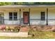Charming porch featuring brick base, colorful flowers, a 'WELCOME' sign and the number '304' at 304 W Fourth St, Cherryville, NC 28021
