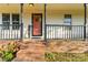 Inviting entrance featuring a brick base, front porch, potted plants, and visible house number at 304 W Fourth St, Cherryville, NC 28021