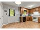 Efficient kitchen layout with wood cabinets, practical appliances, and view to backyard through window at 304 W Fourth St, Cherryville, NC 28021