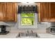 Bright kitchen features stainless sink with window view and sleek counter tops at 304 W Fourth St, Cherryville, NC 28021