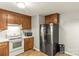 Bright kitchen features updated stainless steel appliances and wood cabinets for ample storage space at 304 W Fourth St, Cherryville, NC 28021