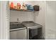 Convenient laundry area features modern appliances, storage shelf, and easy access at 304 W Fourth St, Cherryville, NC 28021