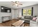 Spacious living room featuring a large window, ceiling fan, and stylish, dark wood flooring at 304 W Fourth St, Cherryville, NC 28021