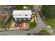 View from above of building's parking lot, with several cars, and street access, edged by landscaping and neighboring structures at 310 4Th W St, Newton, NC 28658