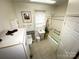 Functional bathroom featuring a tub/shower combo, white fixtures, and a window for natural light at 310 4Th W St, Newton, NC 28658
