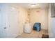 Hallway area with tiled floor, an exit sign, a small refrigerator, and a blue chair with a blanket at 310 4Th W St, Newton, NC 28658