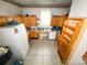 Kitchen area featuring wooden cabinets, white appliances, and a neutral-toned floor, showing contents needing organization at 310 4Th W St, Newton, NC 28658