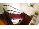 Carpeted staircase with metal railing and good visibility, offering safe access between levels at 310 4Th W St, Newton, NC 28658