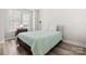 Cozy bedroom with large windows, laminate flooring, comfortable bed and modern furniture at 3223 Beans Blvd, Charlotte, NC 28203