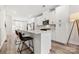 Open kitchen with white cabinets, bar seating, stainless appliances and adjacent dining area at 3223 Beans Blvd, Charlotte, NC 28203