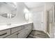 Bathroom featuring double sinks, wood look tile floors, and a framed oval mirror at 338 Livingston Dr, Lancaster, SC 29720