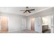 Bedroom featuring a ceiling fan, neutral carpet, and open doors to closet and bathroom at 338 Livingston Dr, Lancaster, SC 29720