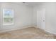 Bedroom with neutral carpet, window and door painted white, and new construction feel at 338 Livingston Dr, Lancaster, SC 29720