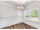 Elegant dining room featuring wood floors, wainscoting, and a stylish chandelier at 338 Livingston Dr, Lancaster, SC 29720
