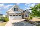 Charming home featuring stone accents, a two-car garage, and well-maintained landscaping at 338 Livingston Dr, Lancaster, SC 29720