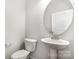 Compact powder room featuring a pedestal sink and toilet at 338 Livingston Dr, Lancaster, SC 29720
