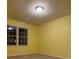 Bright yellow bedroom with carpet and large windows providing ample natural light at 3498 Yorkland Dr, Hickory, NC 28601