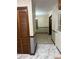 Hallway view showing closet and doorway, with decorative wallpaper and marble flooring at 3498 Yorkland Dr, Hickory, NC 28601