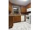Traditional kitchen featuring wood cabinetry, white appliances, and a bright window over the sink at 3498 Yorkland Dr, Hickory, NC 28601