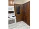 This kitchen includes white appliances and a side door, as well as beautiful floors at 3498 Yorkland Dr, Hickory, NC 28601