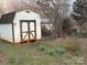 Backyard features white and brown garden shed at 3498 Yorkland Dr, Hickory, NC 28601