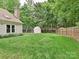Backyard features a lush lawn, fenced perimeter, and storage shed at 3612 Woodnotch Ct, Charlotte, NC 28269