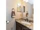 Bathroom featuring granite countertops, bronze fixtures, and a large rectangular mirror at 3612 Woodnotch Ct, Charlotte, NC 28269