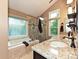Stunning bathroom with granite counters, double sinks, a soaking tub, and a glass-enclosed shower at 3612 Woodnotch Ct, Charlotte, NC 28269