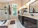 Elegant bathroom featuring double vanities, a soaking tub, and a glass enclosed shower at 3612 Woodnotch Ct, Charlotte, NC 28269