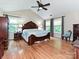Spacious bedroom with hardwood floors, ceiling fan, and windows offering plenty of natural light at 3612 Woodnotch Ct, Charlotte, NC 28269