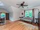 Bright bedroom with hardwood floors, ceiling fan, and natural light from a window at 3612 Woodnotch Ct, Charlotte, NC 28269