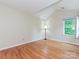 Bright bedroom featuring hardwood floors, and a large window allowing for lots of natural light at 3612 Woodnotch Ct, Charlotte, NC 28269