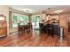 Dining area and kitchen featuring wood floors, large windows, and access to the backyard at 3612 Woodnotch Ct, Charlotte, NC 28269