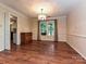 Formal dining room with chandelier lighting, trim accents, and hardwood flooring at 3612 Woodnotch Ct, Charlotte, NC 28269