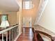 Light-filled foyer with high ceilings, hardwood floors, and elegant staircase at 3612 Woodnotch Ct, Charlotte, NC 28269