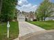 Exterior view of a two-story home showcasing the driveway and well-maintained front lawn at 3612 Woodnotch Ct, Charlotte, NC 28269