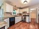 Well-lit kitchen featuring granite countertops, tiled backsplash, stainless steel appliances, and hardwood floors at 3612 Woodnotch Ct, Charlotte, NC 28269