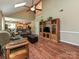 Spacious living room with vaulted ceilings, skylights, ceiling fan, and wood-style flooring at 3612 Woodnotch Ct, Charlotte, NC 28269